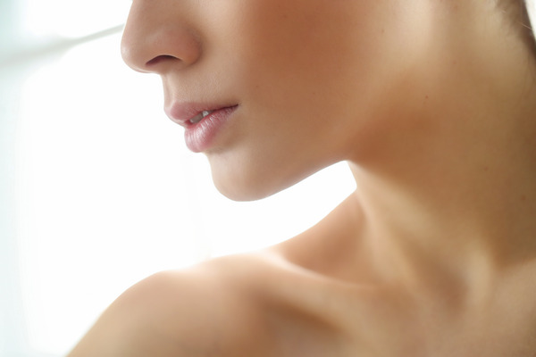 A closeup picture of a woman's perfect jawline after chin augmentation